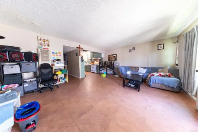 a living room with furniture and a gym machine