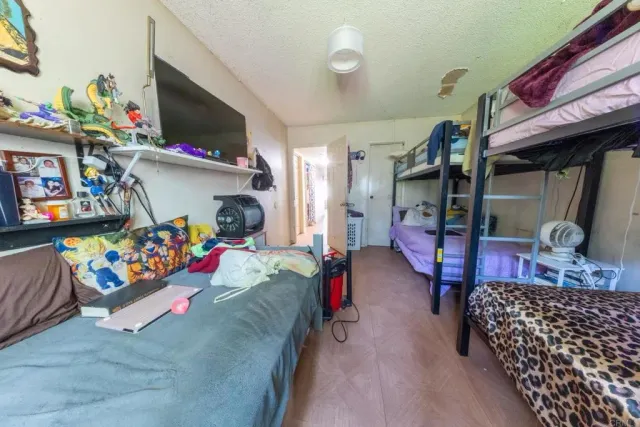 a bedroom with furniture and a flat screen tv