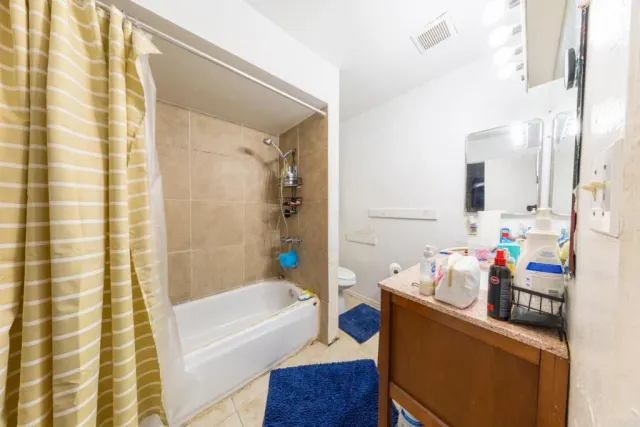 a bathroom with a bath tub a sink and a shower curtain