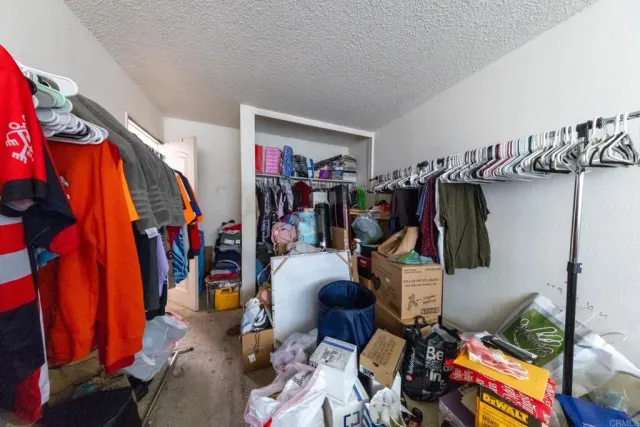 a view of walk in closet with clothes