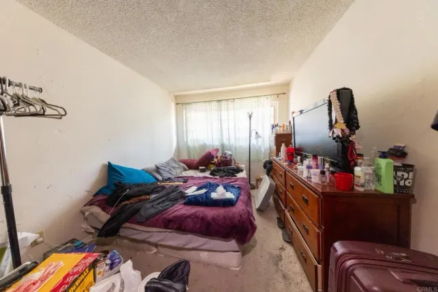 a bed room with a bed and a chair