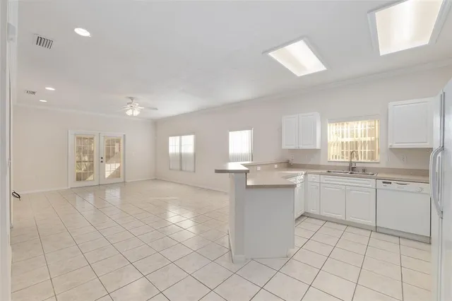 a kitchen with kitchen island a sink appliances and cabinets