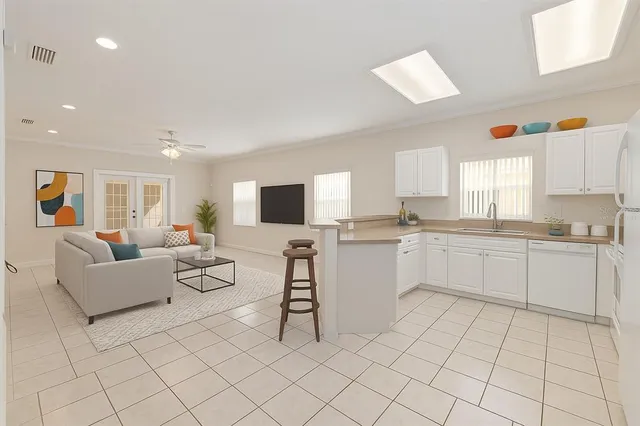 a kitchen that has a stove a sink and a refrigerator