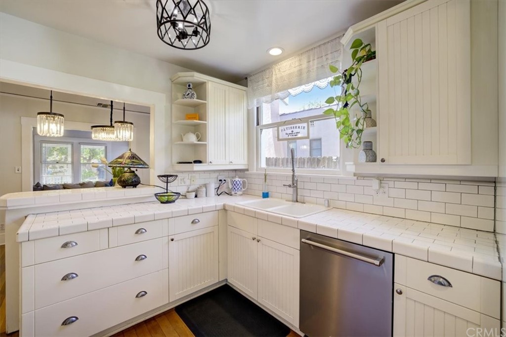 1030 Sinaloa Avenue Pasadena, CA 91104 - Photo 18 of 45 a white kitchen with a sink and a window