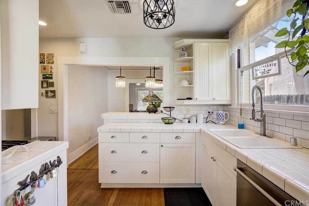 1030 Sinaloa Avenue Pasadena, CA 91104 - Photo 19 of 45 a kitchen with a sink cabinets and wooden floor