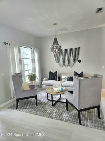 a living room with furniture a rug and a window