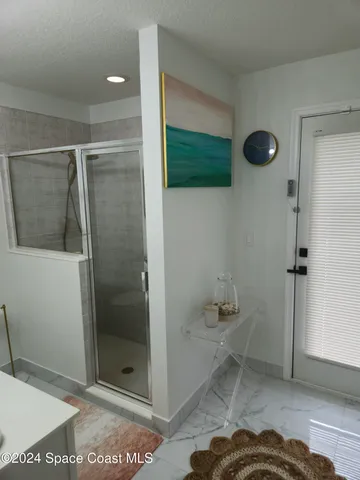 a bathroom with a glass shower door