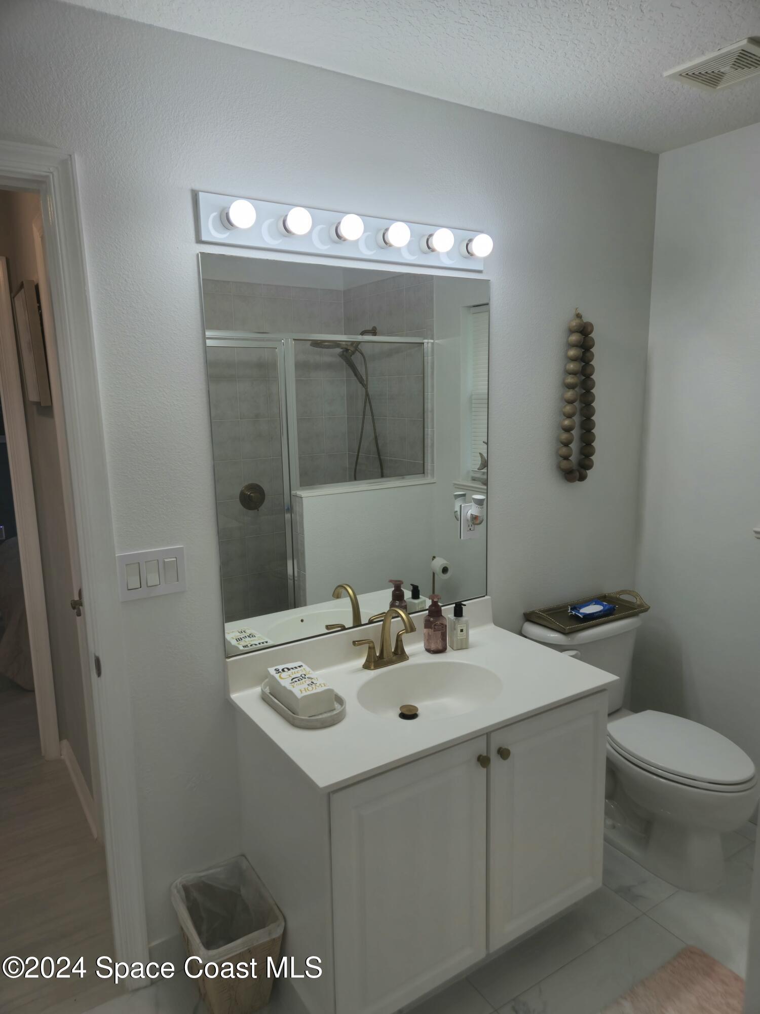 491 South Key Lime Square Southwest Vero Beach, FL 32968 - Photo 22 of 29 a bathroom with a sink toilet and mirror