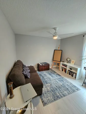 a living room with furniture rug and wooden floor