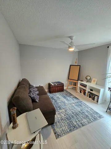 a living room with furniture rug and wooden floor