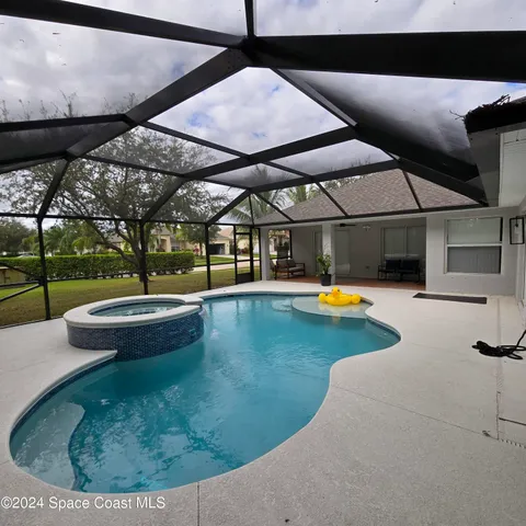 a view of a swimming pool with a yard