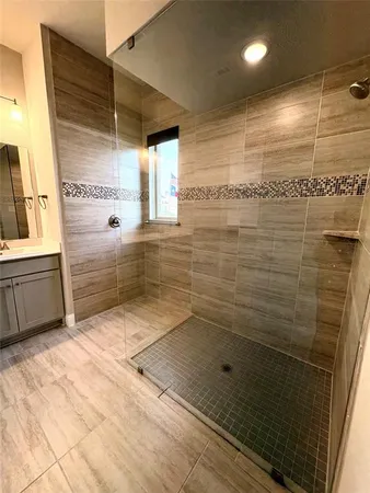 a bathroom with a sink a mirror and shower