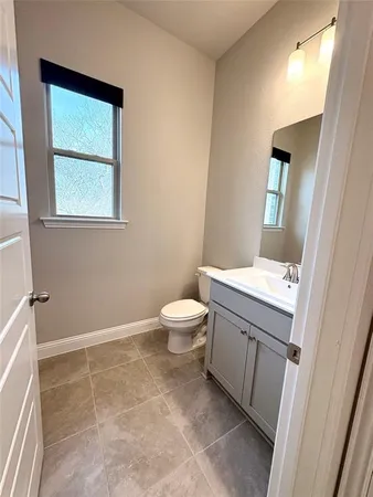 an empty room with windows and fireplace