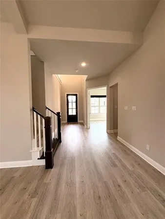 a large kitchen with cabinets wooden floor and stainless steel appliances