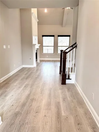 a view of hallway with wooden floor and stairs