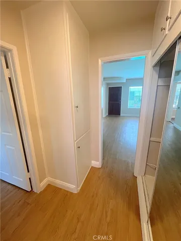 a view of hallway with wooden floor