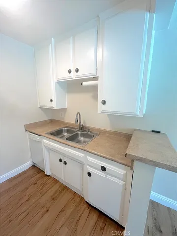 a kitchen with granite countertop a sink and cabinets
