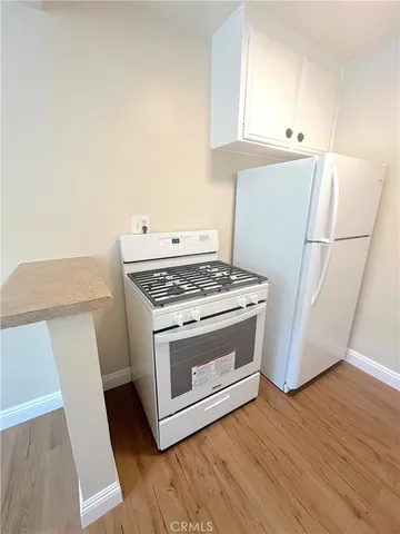a kitchen with granite countertop a stove and a refrigerator
