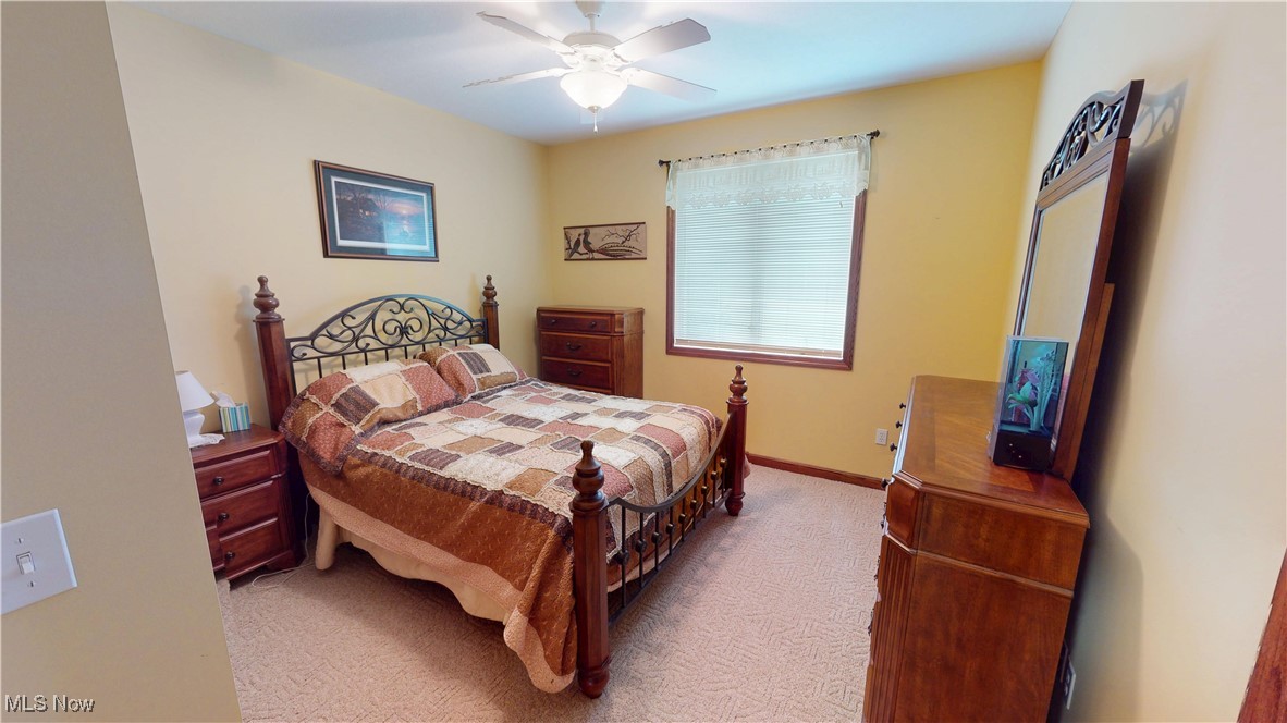 10323 Smith Road Litchfield, OH 44253 - Photo 28 of 50 Bedroom featuring light colored carpet, baseboards, and a ceiling fan