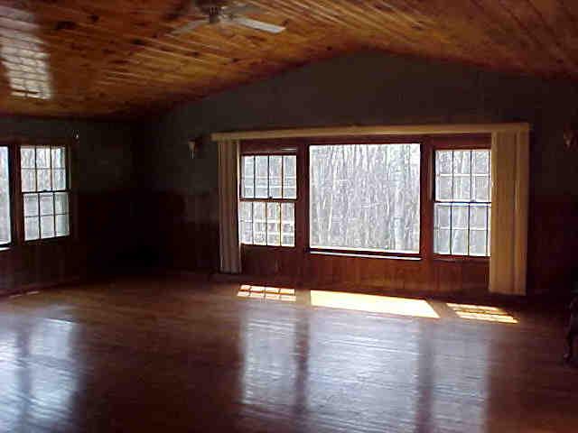 89 West Main Road Peru, MA 01235 - Photo 2 of 2 an empty room with wooden floor and windows