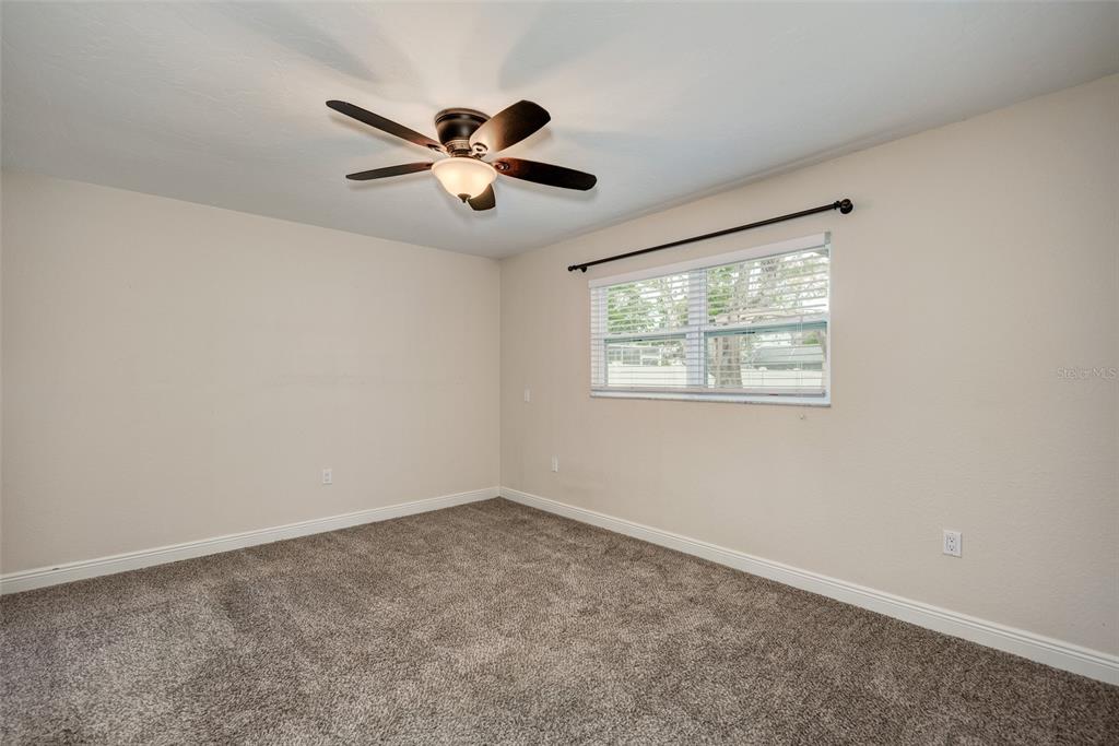 1330 Georgetowne Circle Sarasota, FL 34232 - Photo 22 of 46 a view of a big room with wooden floor and windows