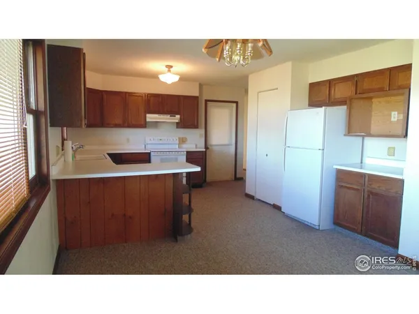 a open living room with a hallway and closet