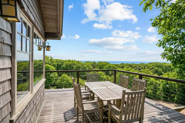 a view of a balcony with wooden floor and fence