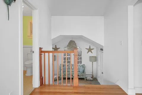 a view of a bedroom with wooden floor and stairs