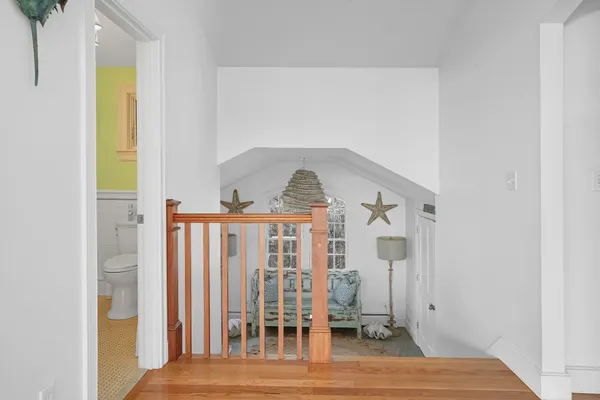 a view of a bedroom with wooden floor and stairs