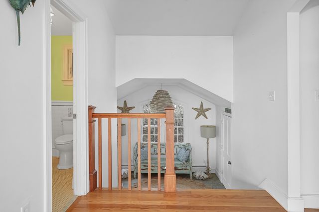 a view of a bedroom with wooden floor and stairs
