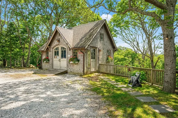 a view of a house with a yard and large tree