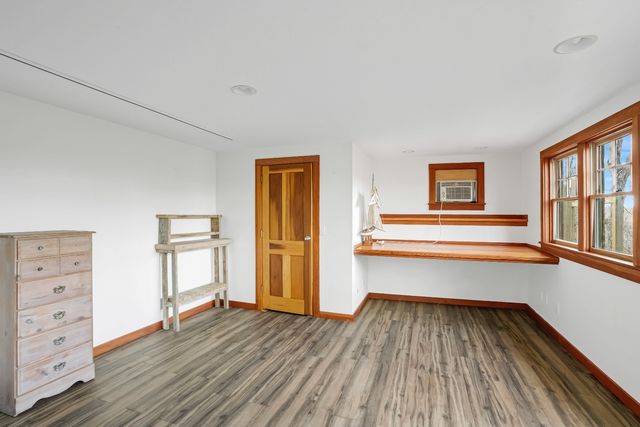 a view of wooden floor and windows in a room