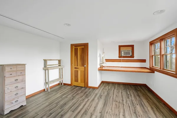 a view of wooden floor and windows in a room