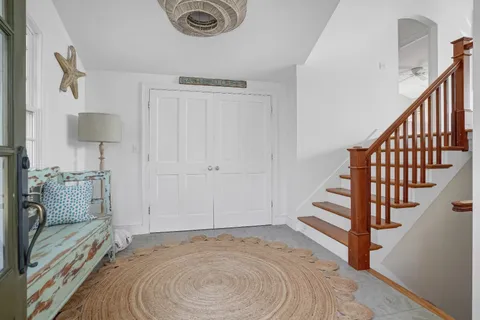 a view of entryway and hall with wooden floor