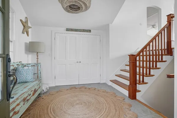 a view of entryway and hall with wooden floor
