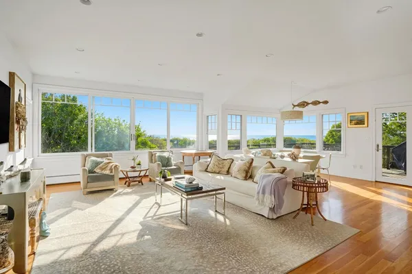 a living room with furniture large window and a flat screen tv