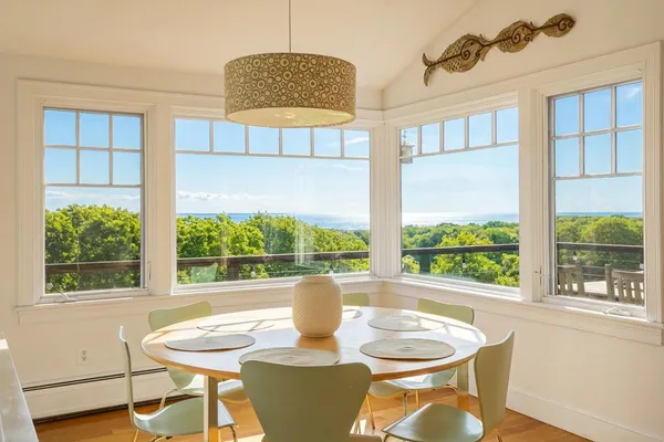 a dining room with furniture a window and a chandelier