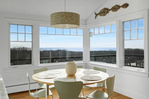 a dining room with furniture a window and a kitchen view