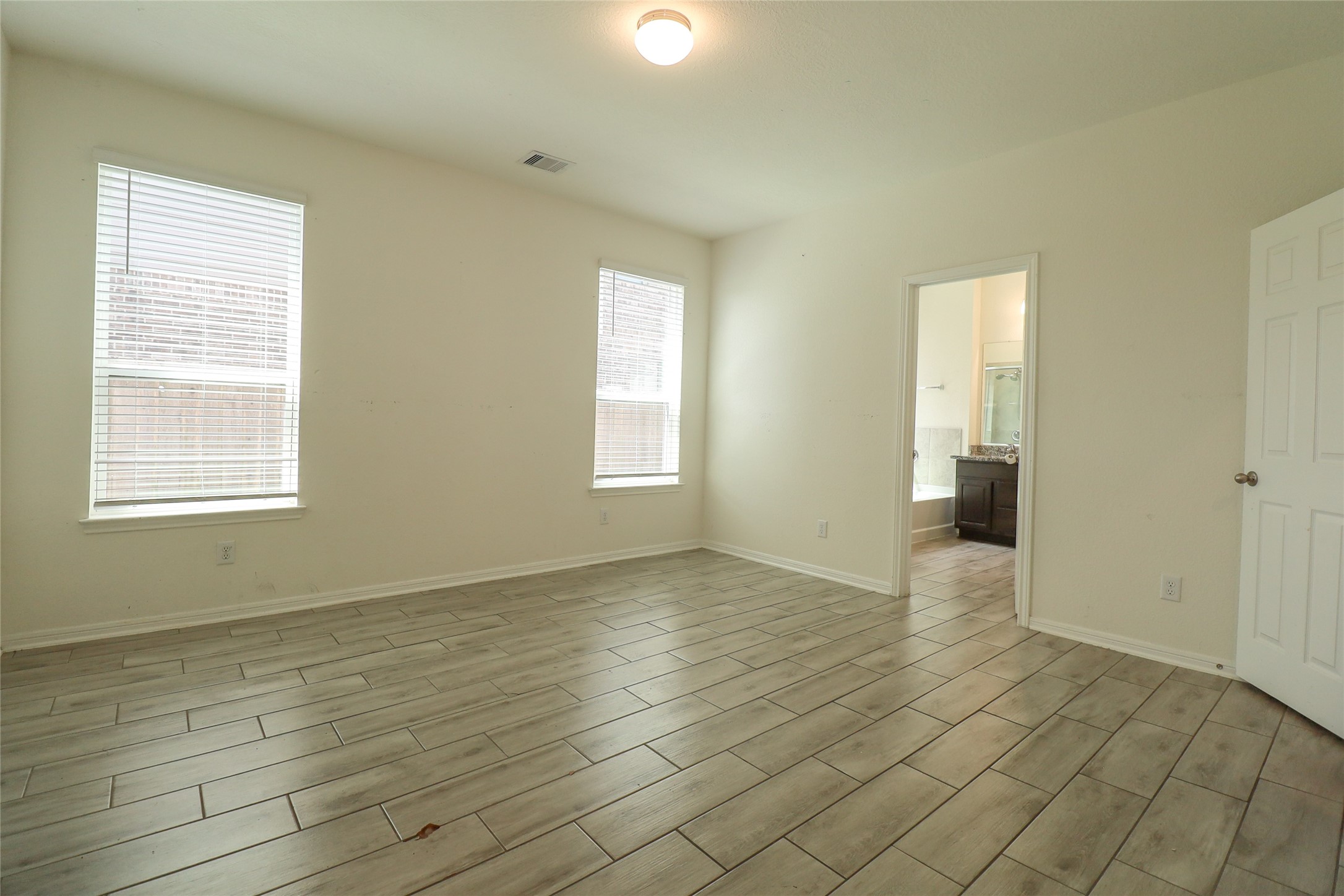 1418 Red Hills Drive Rosharon, TX 77583 - Photo 16 of 36 an empty room with wooden floor and windows