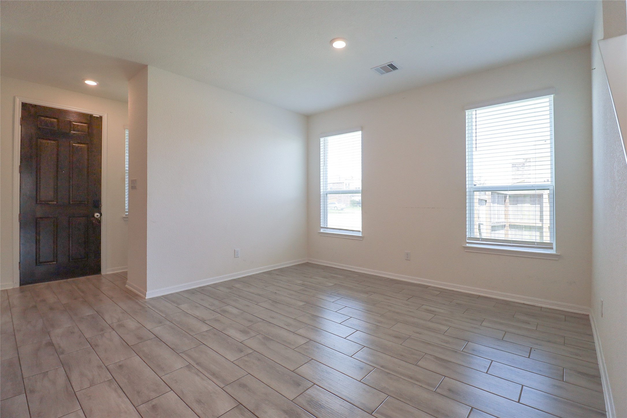1418 Red Hills Drive Rosharon, TX 77583 - Photo 5 of 36 an empty room with wooden floor and windows