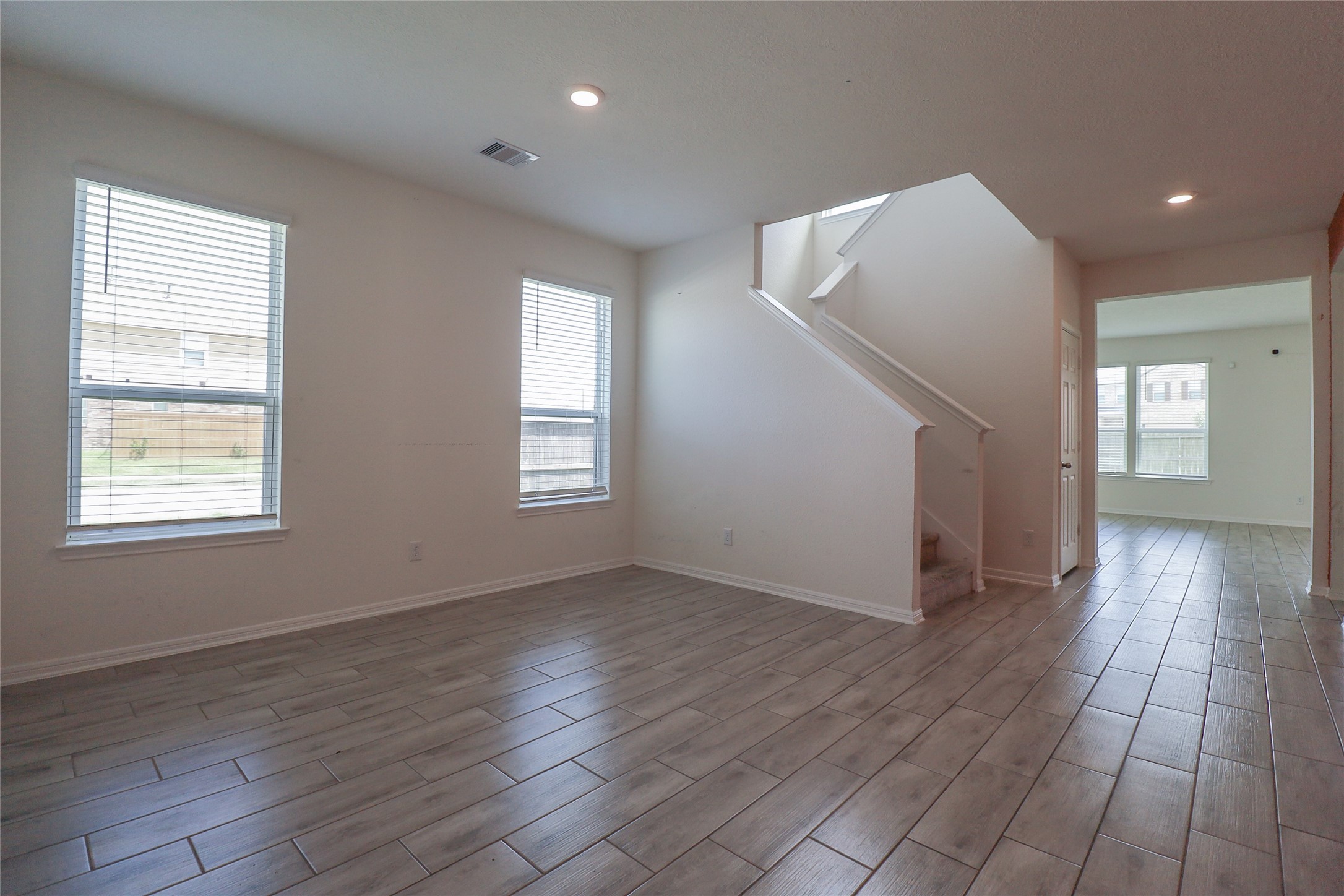 1418 Red Hills Drive Rosharon, TX 77583 - Photo 7 of 36 an empty room with wooden floor and windows
