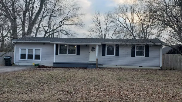 a house that has a tree in the yard