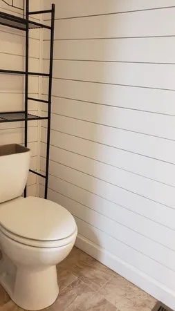 a bathroom with a toilet and a shower