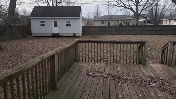 a view of a house with wooden deck