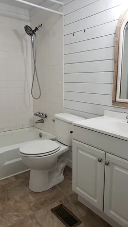 a bathroom with a toilet sink and shower