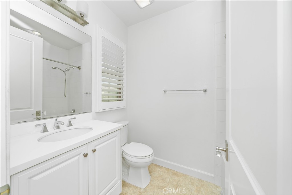64 Hazelton Irvine, CA 92620 - Photo 15 of 20 a bathroom with a sink a toilet and a mirror