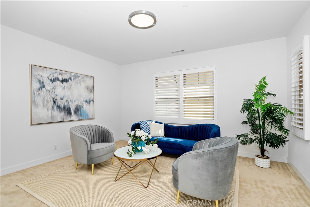 64 Hazelton Irvine, CA 92620 - Photo 10 of 20 a living room with furniture potted plant and a window