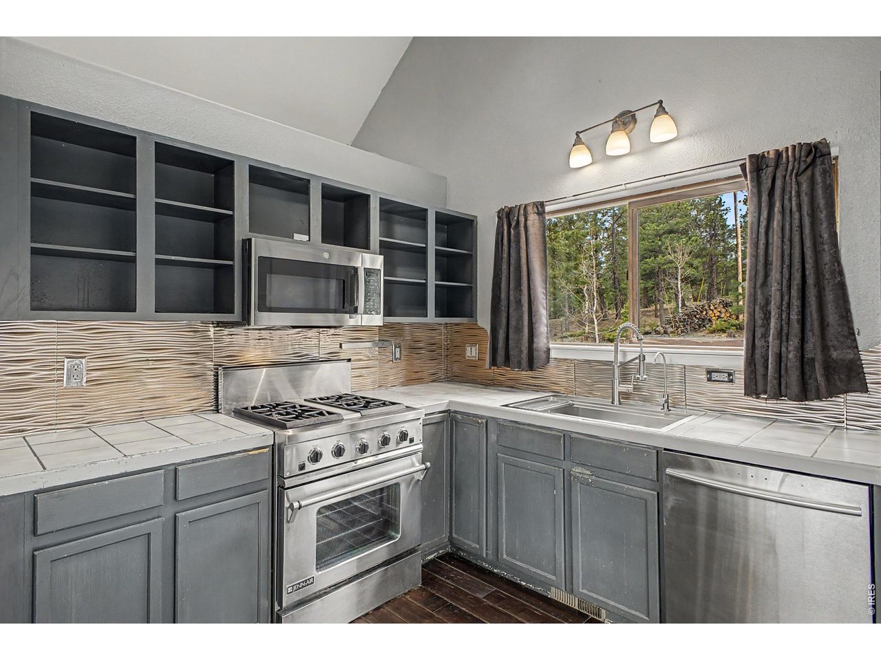 76 Highlands Drive Bailey, CO 80421 - Photo 12 of 49 a kitchen with a sink stove and cabinets