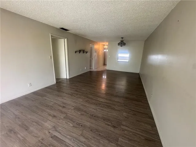 a view of a room with wooden floor