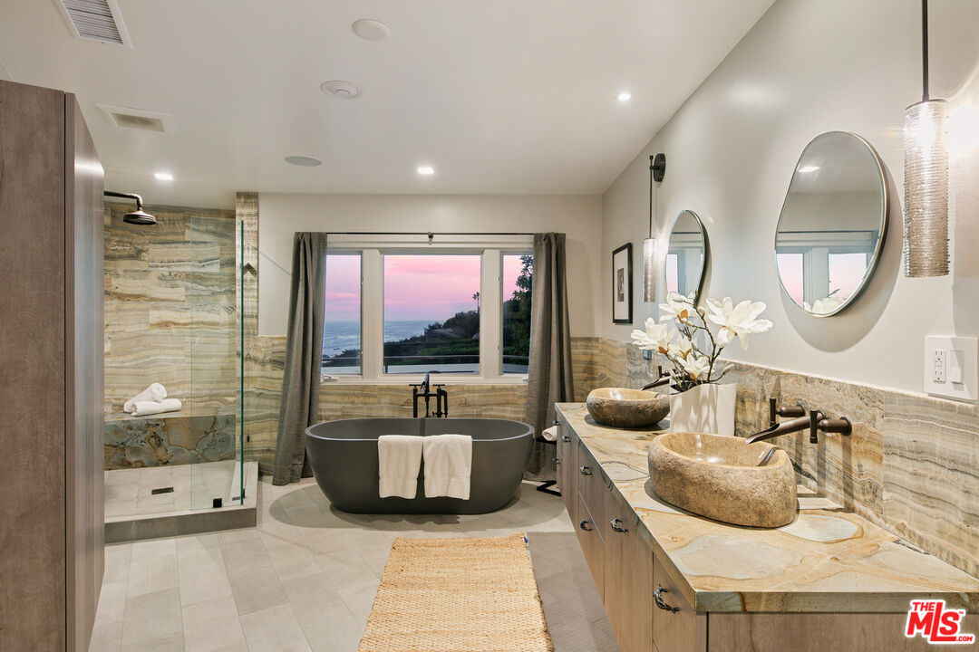 31558 Victoria Point Road Malibu, CA 90265 - Photo 35 of 55 a large bedroom with a large bed and a mirror